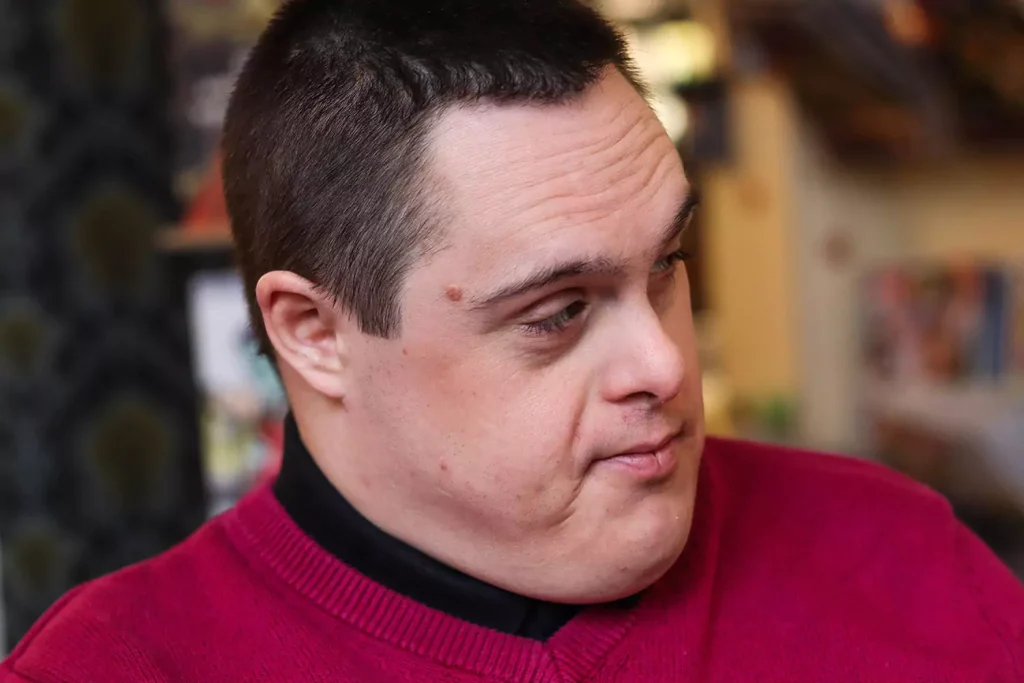 Disabled man wearing red jumper