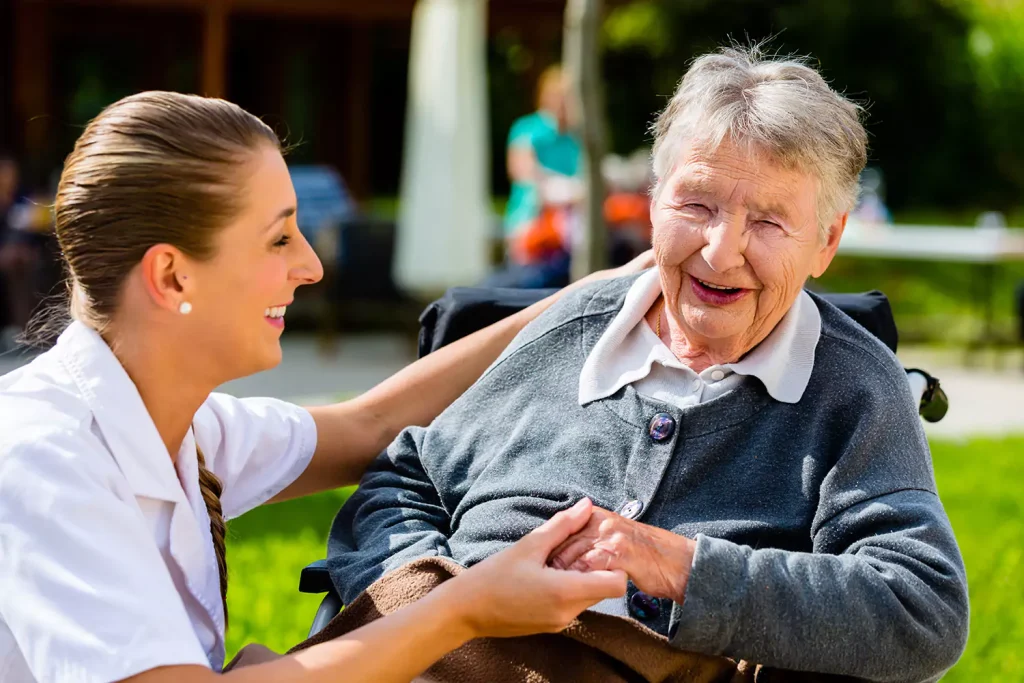 Nurse smiling with disabled woman in wheelchair